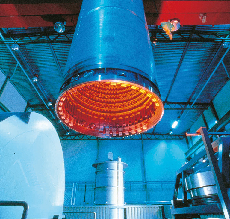 The capsule is HIPed using high temperature and pressure, fully densifying the powder metal and bonding it to the steel bar, creating a coating (cladding).