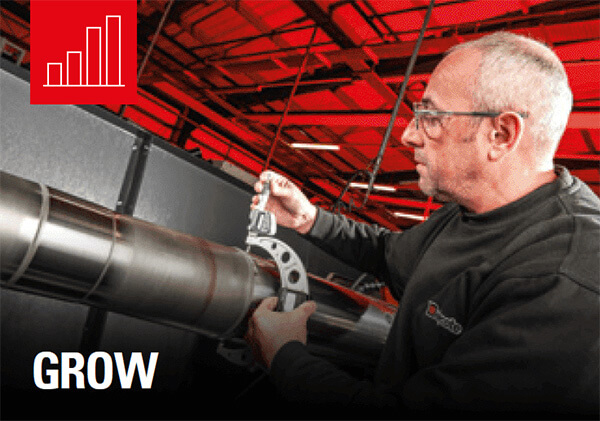 Man with glasses using a calliper to measure a metal pipe in an industrial workshop; red chart icon and the word GROW visible.
