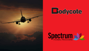 Aeroplane flying towards sunset with Bodycote logo in black and red and Spectrum Thermal Processing logo featuring a colourful flower.
